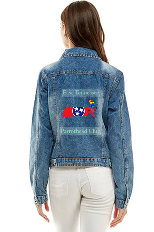 A Lady wearing a blue denim jacket featuring the East Tennessee Parrothead Club logo with writing in green pastel.